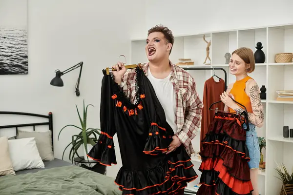 Two friends joyfully engage in a fashion moment at home, sharing outfits and laughter. — Stock Photo