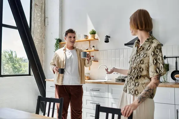 Two friends enjoy a joyful conversation over coffee in a cozy kitchen. — Stock Photo