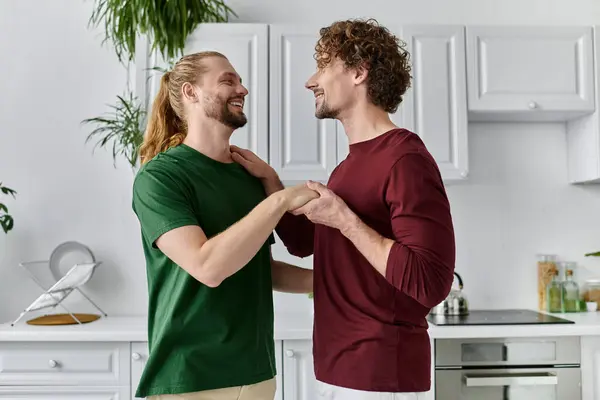 Two partners share a tender moment while preparing a meal in their cozy kitchen. — Stock Photo