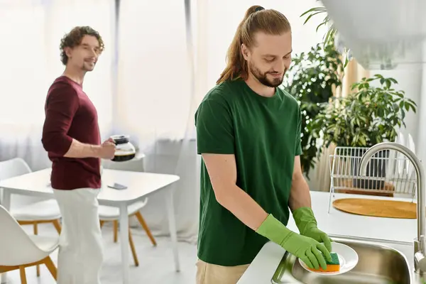 Two partners share tender moments while doing chores at home. — Stock Photo