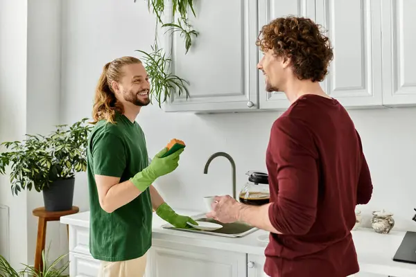 Two partners share laughter while preparing a meal in their cozy kitchen. — Stock Photo