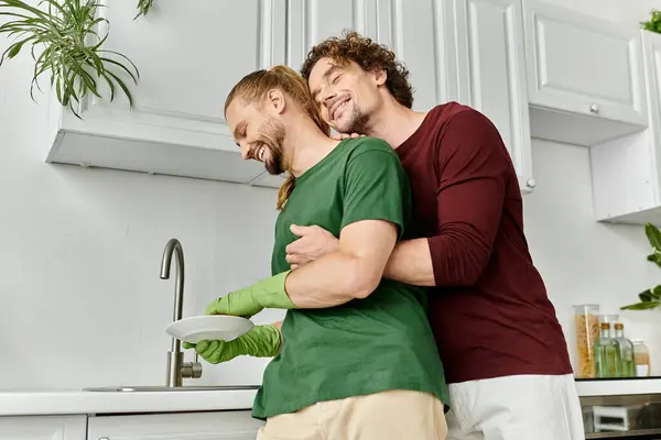 A loving couple enjoys cooking together in their bright home kitchen. — Stock Photo