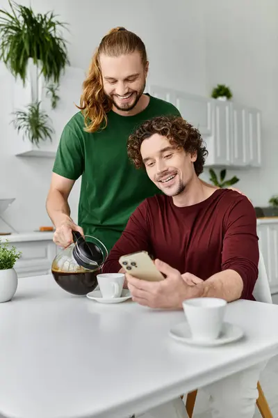 A joyful couple shares a moment while brewing coffee and enjoying each others company. — Stock Photo