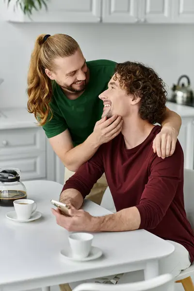A joyful couple shares a tender moment while enjoying coffee at home. — Stock Photo