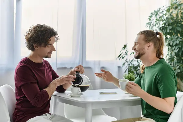 A happy couple enjoys coffee together, sharing smiles in their cozy home. — Stock Photo