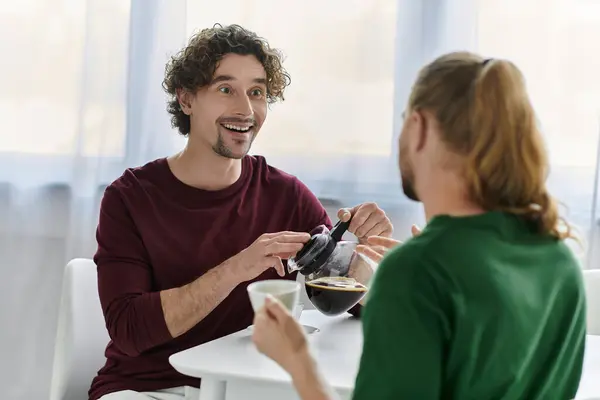 A couple shares laughter and coffee in their cozy kitchen. — Stock Photo