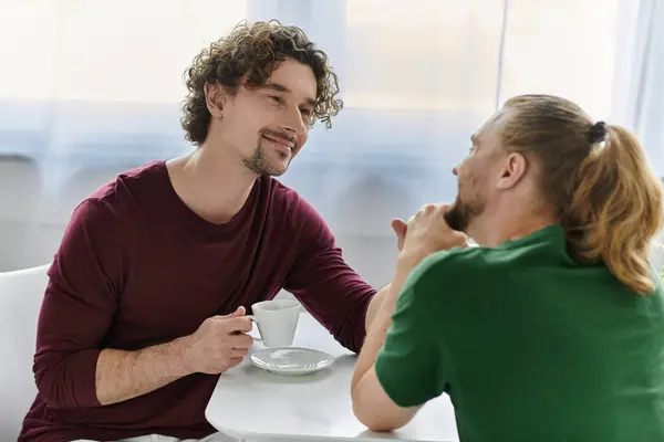 Two men share a warm and intimate moment over coffee at home. — Stock Photo