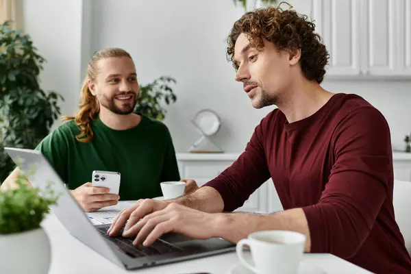 A happy couple enjoys quality time while working on a laptop at home. — Stock Photo