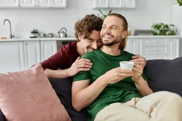 Joyful couple sharing warmth and laughter while embracing at home. — Stock Photo