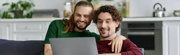 Couple shares laughter while watching something on their laptop at home. — Stock Photo