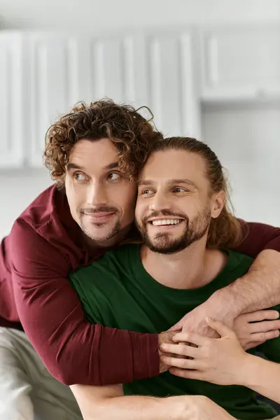 A loving couple shares a warm embrace and joyful laughter at home. — Stock Photo
