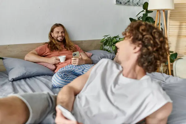 Two partners share smiles and warmth in their cozy bedroom. — Stock Photo