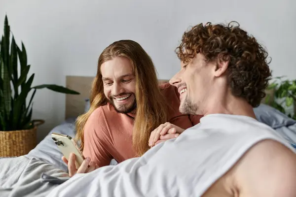 Two men share laughter and joy while enjoying time together in bed. — Stock Photo