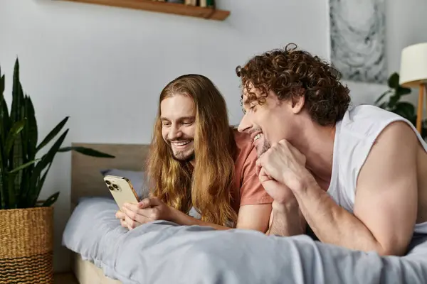 Two partners enjoying each other while browsing on a smartphone. — Stock Photo