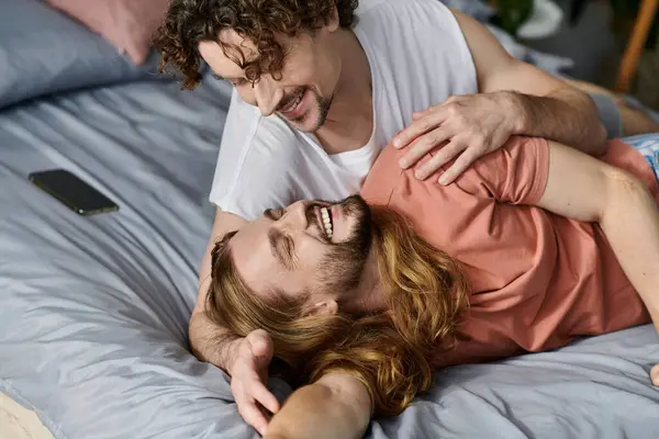Couple shares laughter and affection in a warm, intimate home environment. — Stock Photo