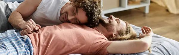 A joyful couple shares tender moments while lounging on a comfortable bed. — Stock Photo