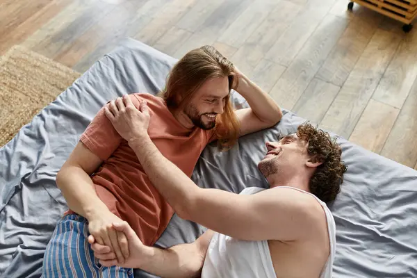 Two partners share affectionate moments while lounging comfortably together. — Stock Photo