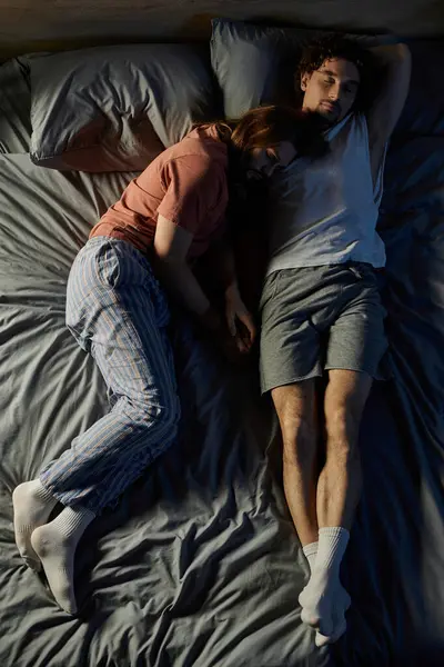 A tender moment as two men rest closely together in bed, embracing warmth and comfort. — Stock Photo