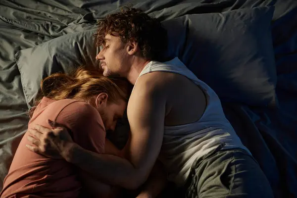 A tender moment shared between two partners in bed. — Stock Photo
