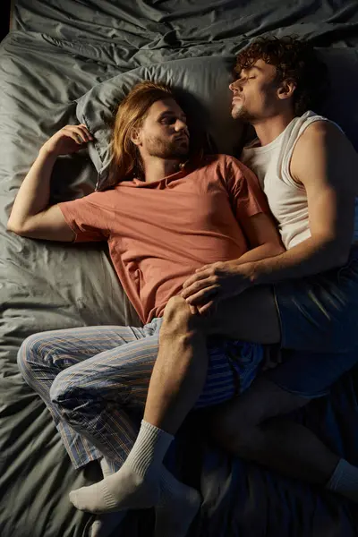 Two loving partners share a cozy embrace on their bed, radiating warmth and affection. — Stock Photo