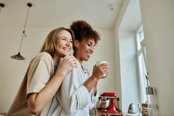 Two smiles shine brightly as a couple shares a fun coffee moment indoors. — Stock Photo