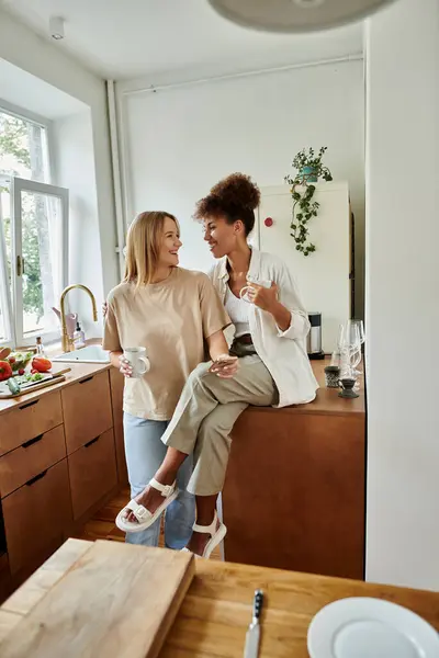 Two women enjoy a relaxed morning together, laughing and sharing coffee. — Stock Photo
