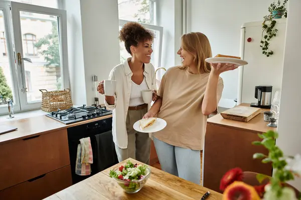 Two partners share a light-hearted moment while preparing breakfast. — Stock Photo