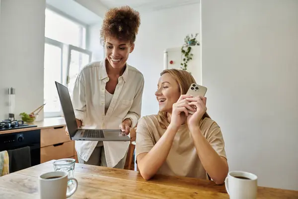 A happy couple enjoys their morning, laughing and sharing moments over coffee. — Stock Photo