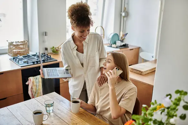 Couple laughs together while sharing a peaceful morning in their stylish kitchen. — Stock Photo