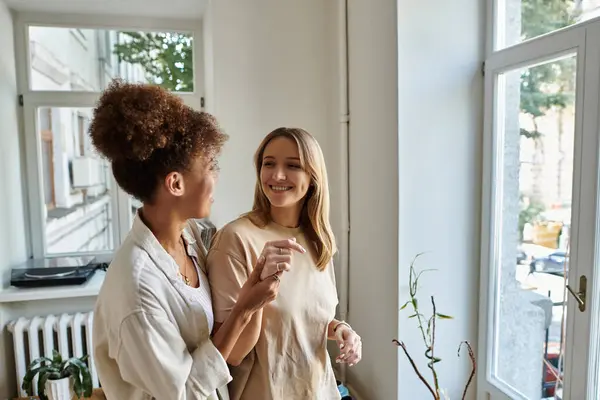 A happy couple shares a moment of affection in a sunlit room. — Stock Photo