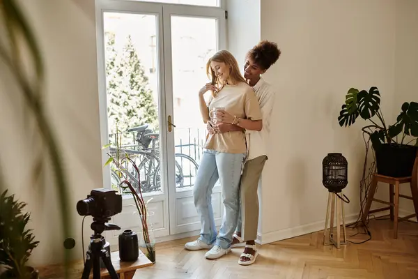 Couple embraces warmly while sharing laughter in their joyful space. — Stock Photo
