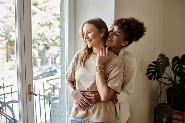 A loving couple shares a warm embrace, enjoying each other's company indoors. — Stock Photo