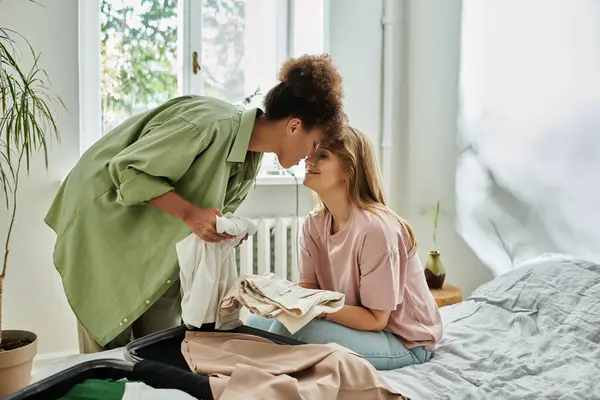 A couple embraces affectionately while sorting their belongings together. — Stock Photo