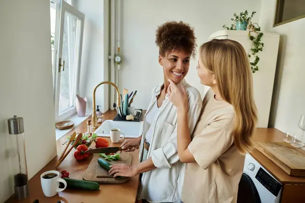 Loving couple enjoys cooking and sharing tender moments in a cozy kitchen. — Stock Photo