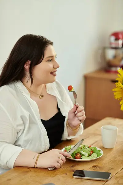 A joyful woman savoring a healthy meal with a content smile. — Stock Photo