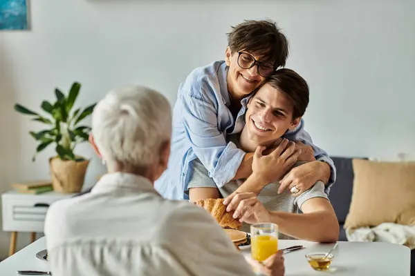 A loving LGBTQ family enjoys breakfast together, sharing laughter and conversation, creating cherished memories. — Stock Photo