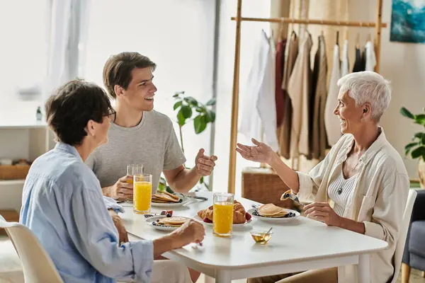 A warm and lively breakfast where a family shares laughter and delicious food together. — Stock Photo