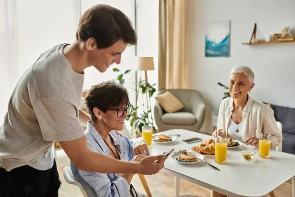 A loving LGBTQ family shares a warm breakfast moment, filled with joy, laughter, and connection. — Stock Photo