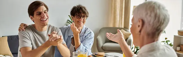 A joyful family enjoys breakfast together, sharing laughter and meaningful conversations in their cozy home. — Stock Photo