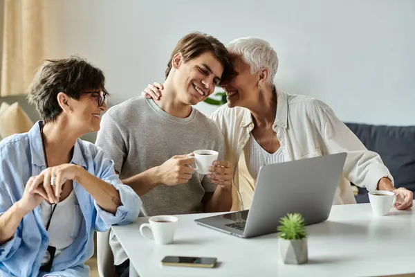 A loving LGBTQ family shares laughter and coffee, creating cherished memories on a cozy morning. — Stock Photo