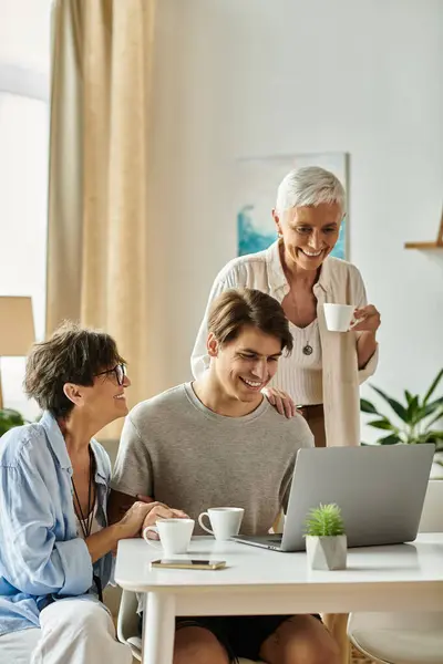 Two loving parents and their adult son bond over a laptop, savoring joyful moments and each other's company. — Stock Photo