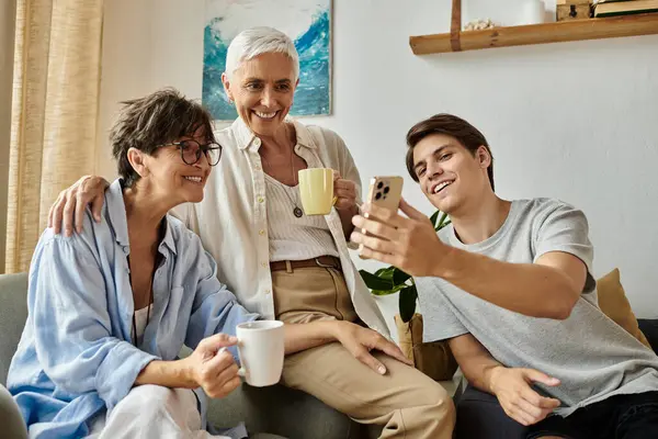 A loving family enjoys a relaxed afternoon sharing laughter and memories over warm drinks. — Stock Photo