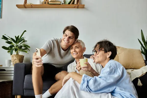 A joyful moment shared between lesbian parents and their adult son, celebrating love and togetherness. — Stock Photo