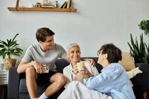 A loving LGBTQ family enjoys quality time together, sharing smiles and laughter in their cozy living room. — Stock Photo