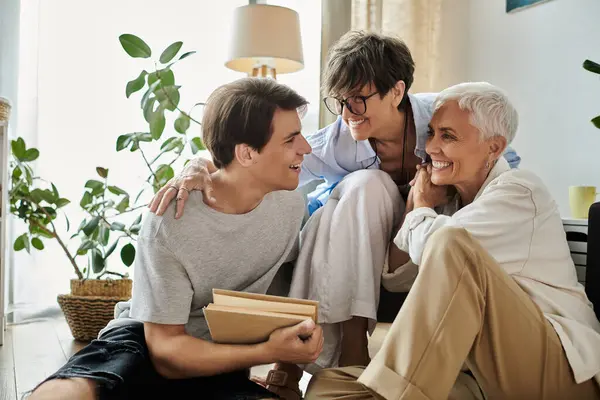 A loving LGBTQ family shares laughter and warmth in a bright living room filled with plants. — Stock Photo