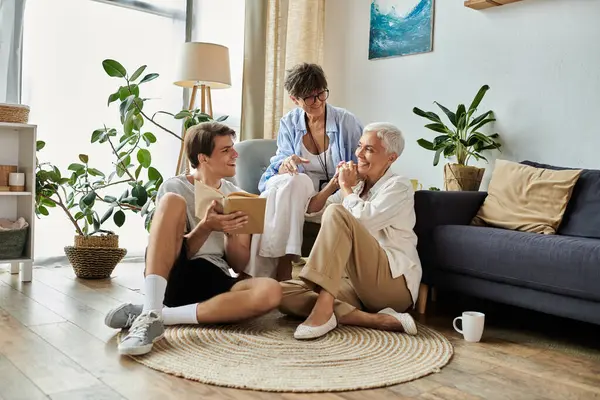 A joyful afternoon as a loving LGBTQ family shares laughter and stories in their cozy living room. — Stock Photo