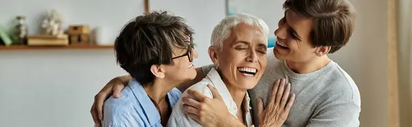 A loving LGBTQ family shares laughter and warmth in their cozy living room, celebrating togetherness and joy. — Stock Photo