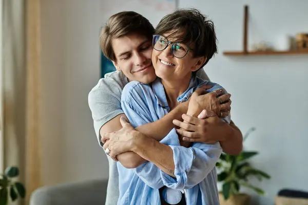 A middle-aged mother and her adult son share a warm hug, enjoying quality time in their inviting home. — Stock Photo