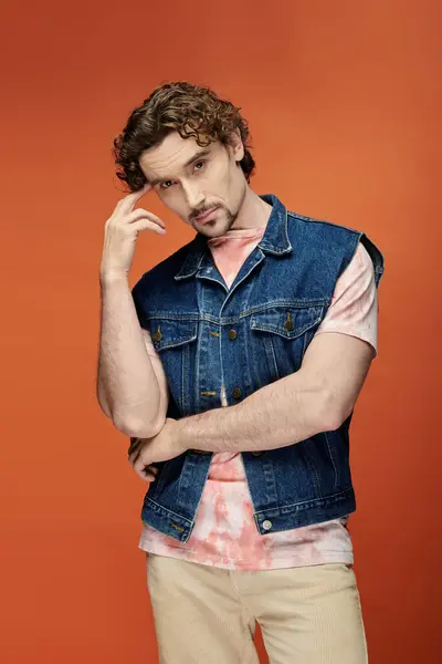 A charming man poses thoughtfully with a vibrant backdrop. — Stock Photo