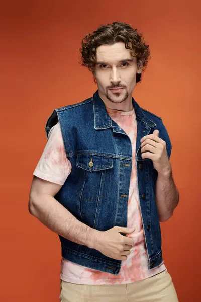 A stylish man expresses emotion in front of a bold, colorful background. — Stock Photo